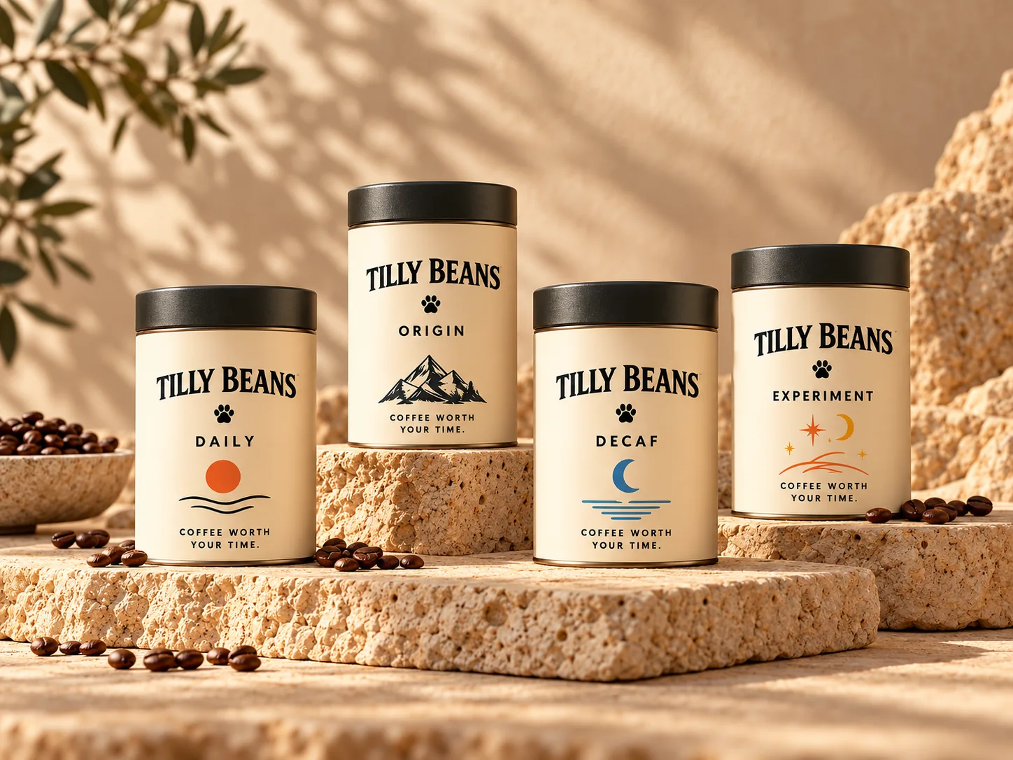 Four Tilly Beans tin concepts — Daily, Origin, Decaf and Experiment — arranged on warm natural stone